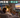 AI-generated illustration of TV speakers and headphones playing together in a Hong Kong living room, with two separate headphones shown in an inset.