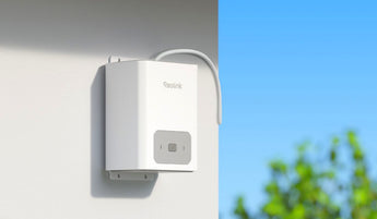 White Reolink RLA-BP1 battery pack mounted on an outdoor wall with its cable