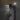 Man walking past a wooden fence at night as the camera spotlight turns on