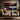A large wall-mounted TV in a modern living room setting, displaying the Netflix app interface with various streaming service logos. The TV is mounted on a textured gray wall above a beige sofa with decorative pillows and a black coffee table in front.