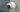 P344 dome camera on a concrete wall with rain falling beside it