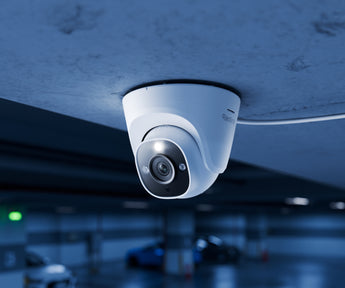 White Reolink RP-PCT12M dome camera mounted on the ceiling of a car park