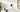 E1 Zoom on a white sideboard with a cat peeking over the edge