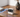 Camera on a wooden table with a blue light trail representing a Wi-Fi signal