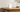 White cylindrical Reolink Home Hub Mini on a wooden table