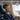 Boy sleeping on a plane wearing blue Q950 headphones, with ANC and transparency icons