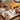 Hands adding a print to a scrapbook on a desk, with a yellow Mini 2 Retro nearby