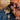 Two kids in blue and purple Q950 headphones, showing ear detection and audio sharing